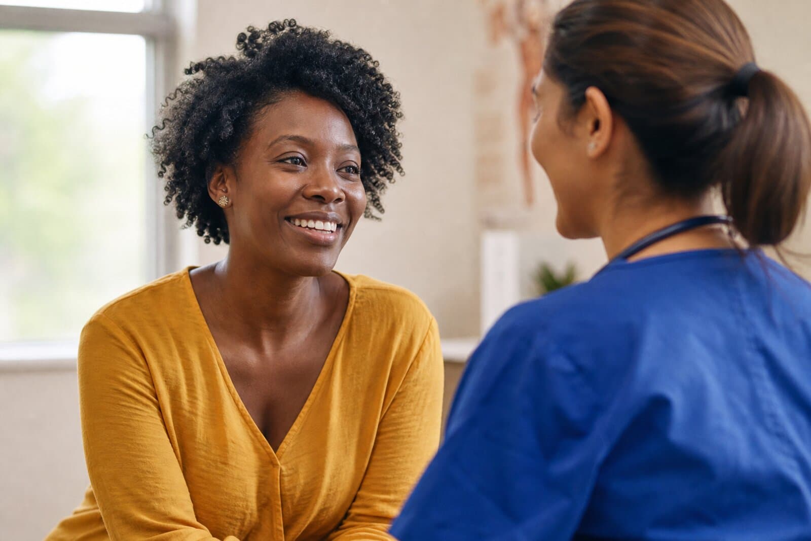 A woman speaking with a health care professional